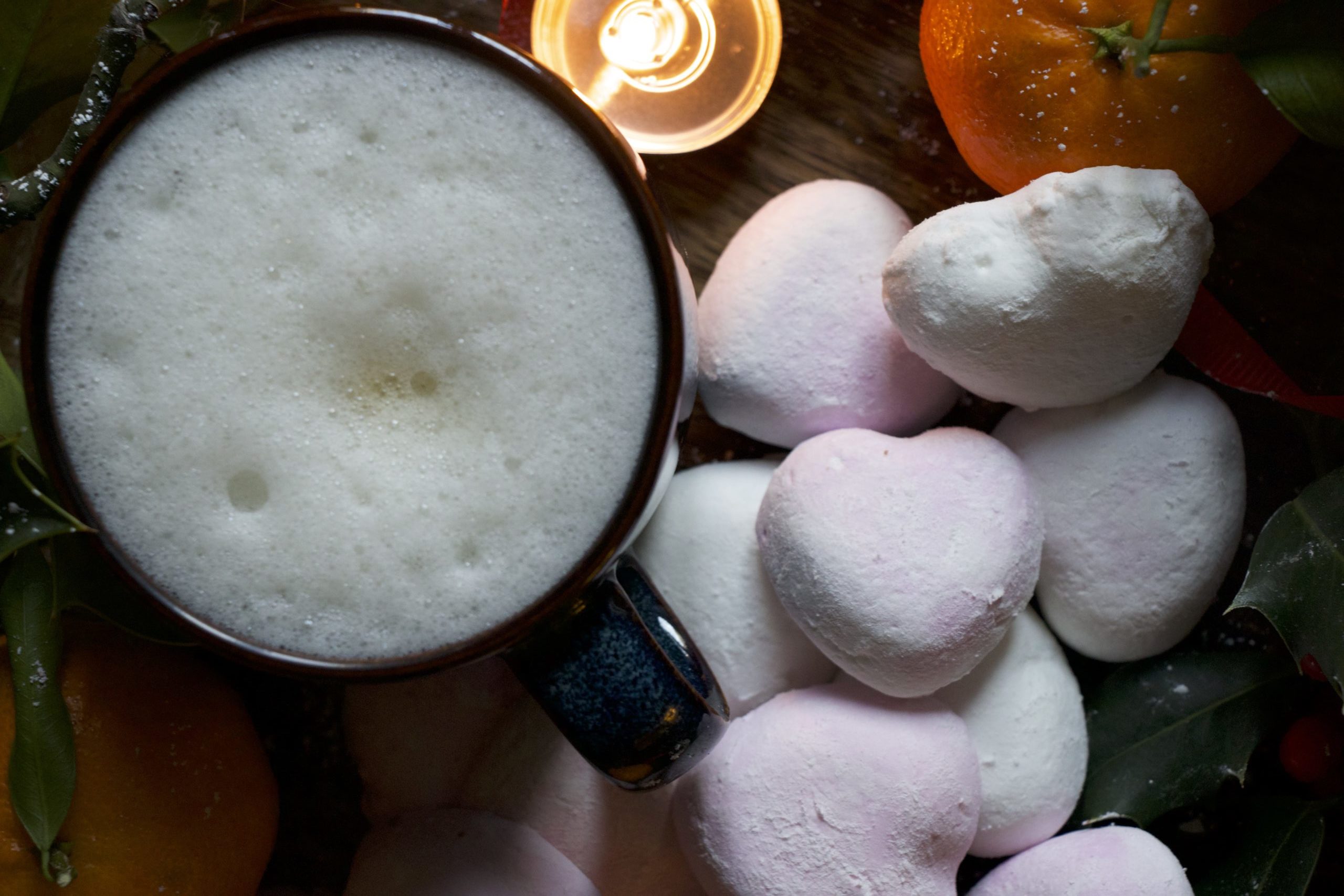 Mix of heart marshmallows on the table with a coffee cup on the side